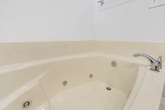 bathroom with a tub with jets