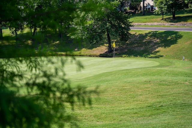 view of home's community featuring a lawn and golf course view