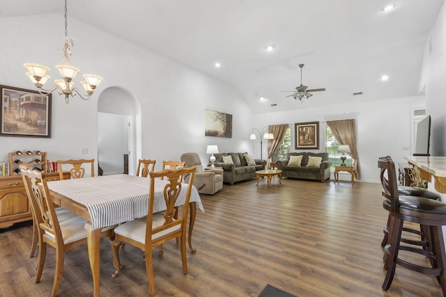 dining room featuring arched walkways, dark wood-style floors, lofted ceiling, and ceiling fan with notable chandelier