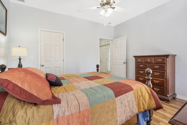 bedroom with visible vents, a ceiling fan, and light wood finished floors