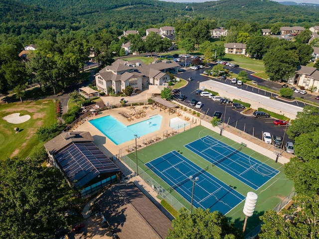 birds eye view of property with a wooded view