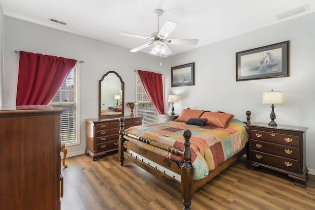bedroom featuring baseboards, a ceiling fan, dark wood-style floors, and visible vents