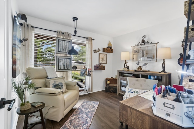 sitting room featuring baseboards and wood finished floors