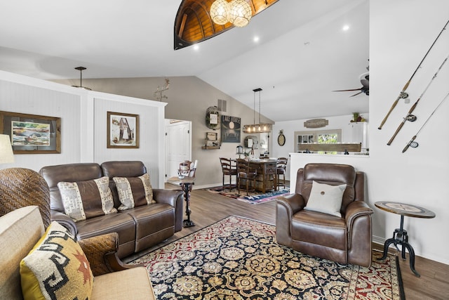 living room with visible vents, a ceiling fan, baseboards, wood finished floors, and vaulted ceiling
