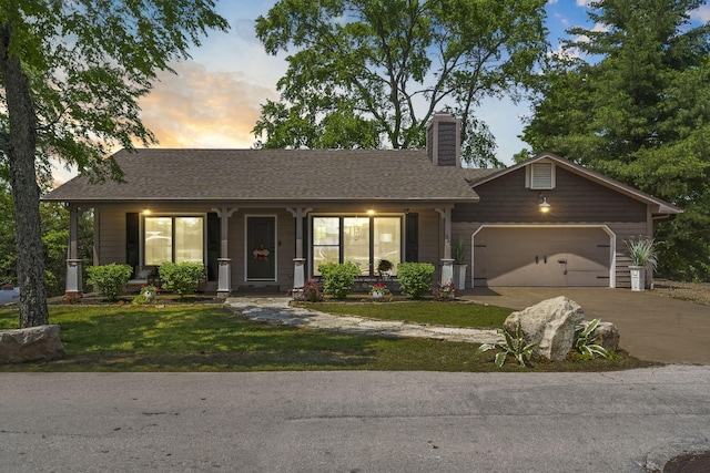 ranch-style house with a garage, covered porch, a front yard, a chimney, and concrete driveway