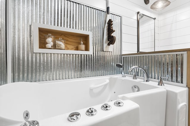 full bathroom with a whirlpool tub