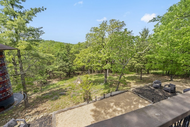 view of yard featuring a forest view and a patio area