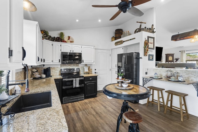 kitchen with a sink, a ceiling fan, dark wood-type flooring, backsplash, and black appliances