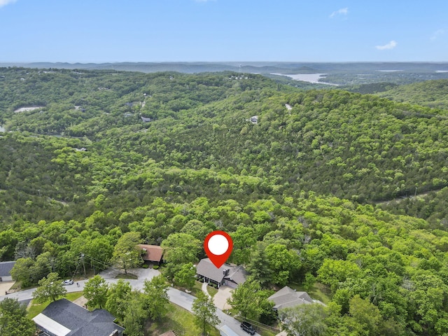 bird's eye view with a wooded view