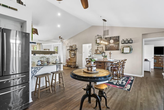 dining room featuring a ceiling fan, baseboards, visible vents, and wood finished floors