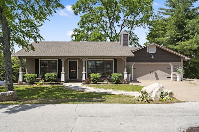 single story home with covered porch, driveway, a chimney, a front yard, and an attached garage