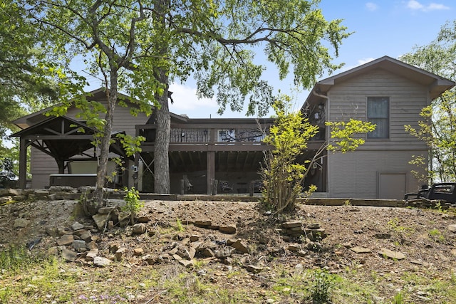 back of house with a wooden deck