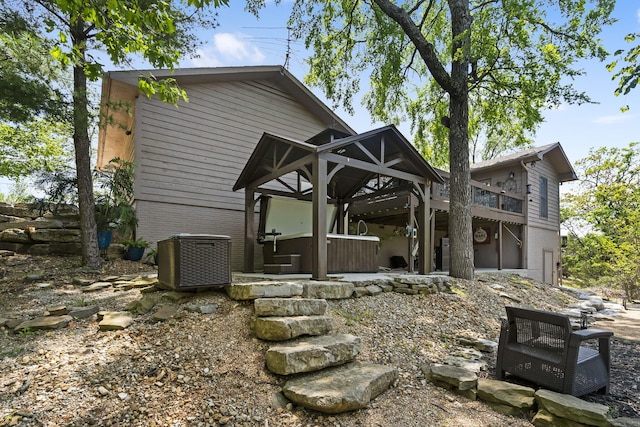 back of property featuring brick siding and central air condition unit