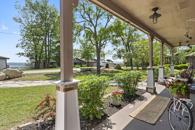 view of patio / terrace with a porch and visible vents