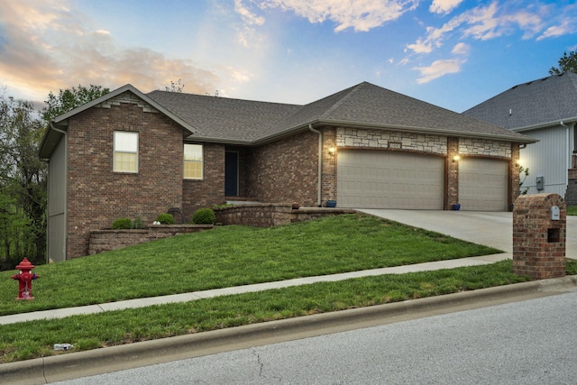 view of front of house featuring roof with shingles, brick siding, a garage, concrete driveway, and a lawn
