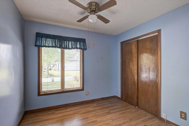 3623 Ridge Dr, Joplin, MO 64801 - unfurnished bedroom with a textured ceiling, a ceiling fan, baseboards, wood finished floors, and a closet