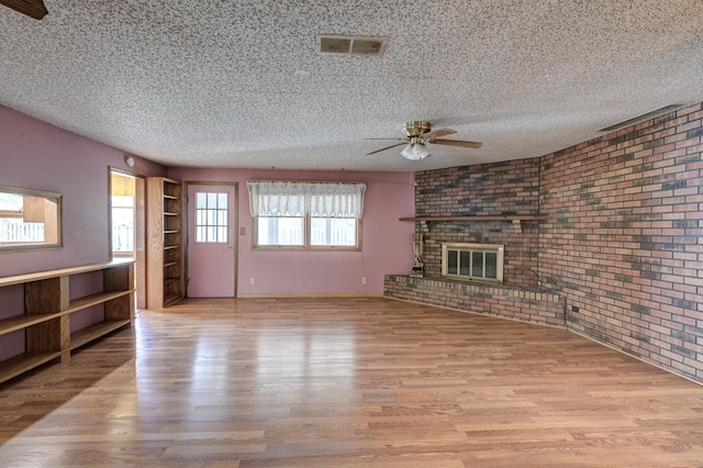 3623 Ridge Dr, Joplin, MO 64801 - unfurnished living room with a textured ceiling, ceiling fan, wood finished floors, and visible vents
