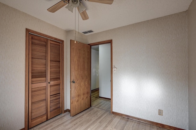 3623 Ridge Dr, Joplin, MO 64801 - unfurnished bedroom with visible vents, a closet, baseboards, ceiling fan, and light wood-type flooring
