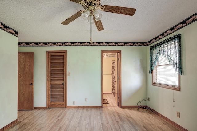 3623 Ridge Dr, Joplin, MO 64801 - unfurnished bedroom with baseboards, ceiling fan, connected bathroom, a textured ceiling, and light wood finished floors