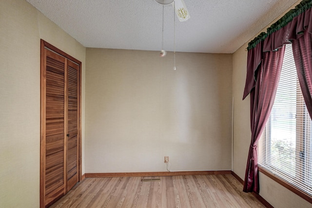 3623 Ridge Dr, Joplin, MO 64801 - unfurnished dining area featuring baseboards, a textured ceiling, light wood finished floors, and ceiling fan