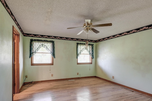 3623 Ridge Dr, Joplin, MO 64801 - spare room with baseboards, a ceiling fan, light wood-type flooring, and a textured ceiling