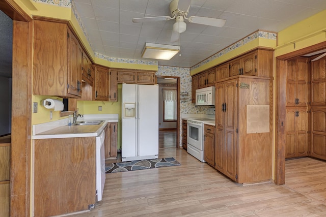 3623 Ridge Dr, Joplin, MO 64801 - kitchen featuring light countertops, brown cabinets, wallpapered walls, and white appliances
