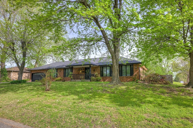 3623 Ridge Dr, Joplin, MO 64801 - ranch-style house featuring brick siding, a front lawn, an attached garage, and covered porch