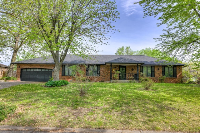 3623 Ridge Dr, Joplin, MO 64801 - ranch-style home featuring brick siding, a garage, aphalt driveway, and a front yard