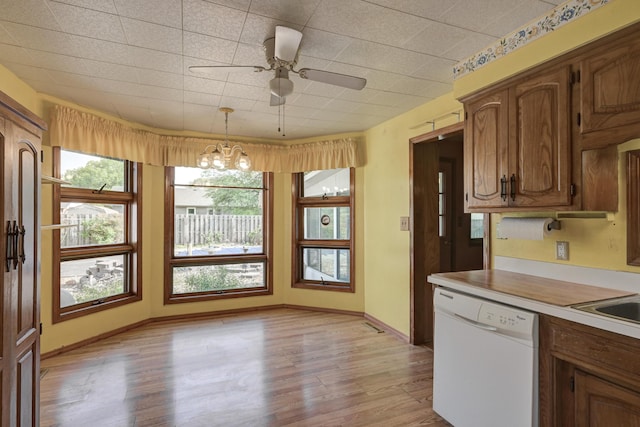 3623 Ridge Dr, Joplin, MO 64801 - kitchen with white dishwasher, pendant lighting, light wood-type flooring, light countertops, and ceiling fan with notable chandelier