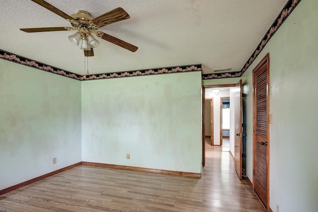 3623 Ridge Dr, Joplin, MO 64801 - empty room featuring a textured ceiling, baseboards, a ceiling fan, and wood finished floors