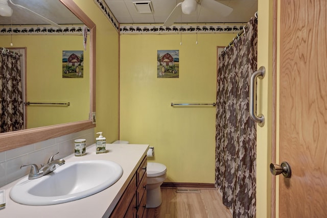 3623 Ridge Dr, Joplin, MO 64801 - bathroom featuring visible vents, vanity, wood finished floors, toilet, and backsplash
