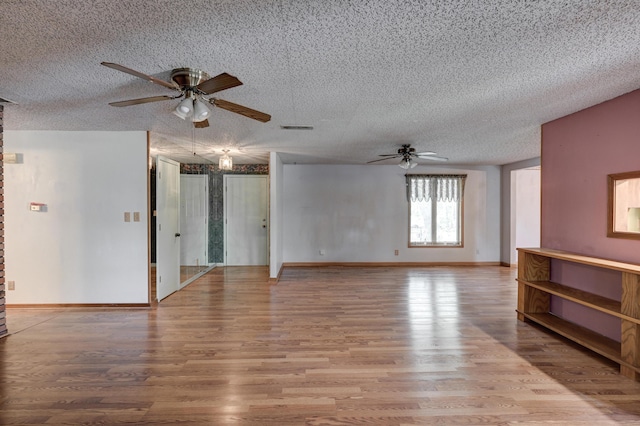 3623 Ridge Dr, Joplin, MO 64801 - unfurnished room featuring visible vents, a textured ceiling, ceiling fan, and wood finished floors