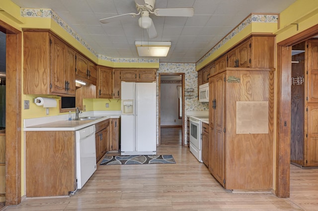 3623 Ridge Dr, Joplin, MO 64801 - kitchen featuring a ceiling fan, a sink, light wood-style floors, wallpapered walls, and white appliances