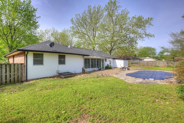 3623 Ridge Dr, Joplin, MO 64801 - back of property with a fenced backyard, a sunroom, a fenced in pool, and a yard