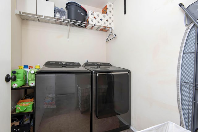 clothes washing area with separate washer and dryer and laundry area