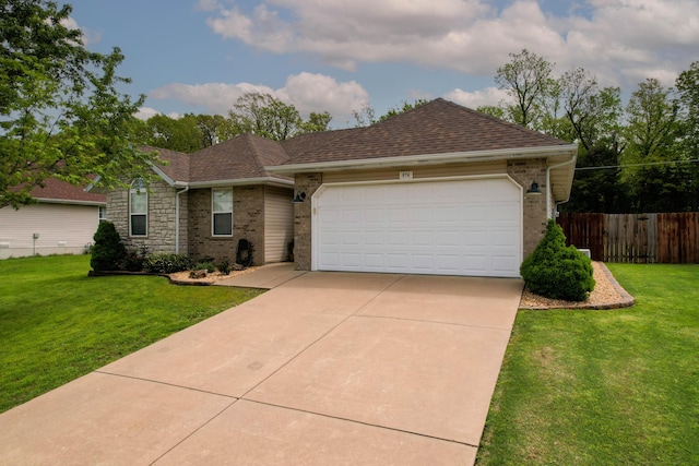 single story home with an attached garage, fence, driveway, and a front lawn