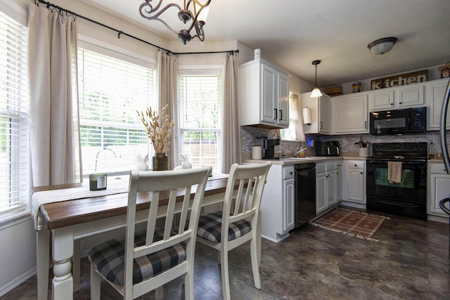 kitchen featuring decorative backsplash, pendant lighting, black appliances, and a wealth of natural light