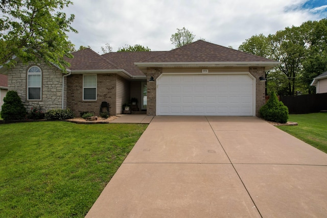 ranch-style home featuring roof with shingles, an attached garage, a front lawn, brick siding, and concrete driveway