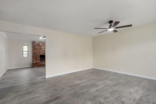 unfurnished living room featuring baseboards, ceiling fan, and wood finished floors