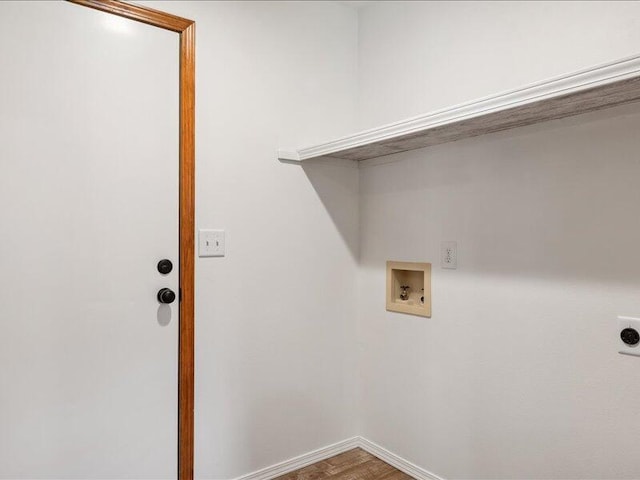 clothes washing area with hookup for an electric dryer, laundry area, wood finished floors, baseboards, and hookup for a washing machine