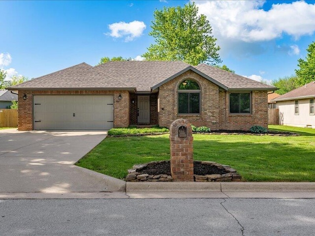 ranch-style home with brick siding, a garage, driveway, and a front yard