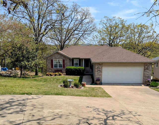 single story home with a garage, a front lawn, brick siding, a shingled roof, and driveway