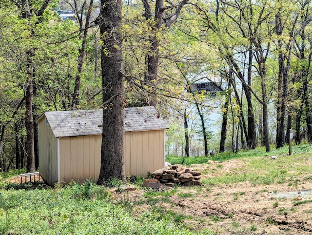 view of shed featuring a forest view