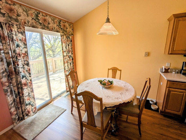dining room featuring baseboards and dark wood-type flooring