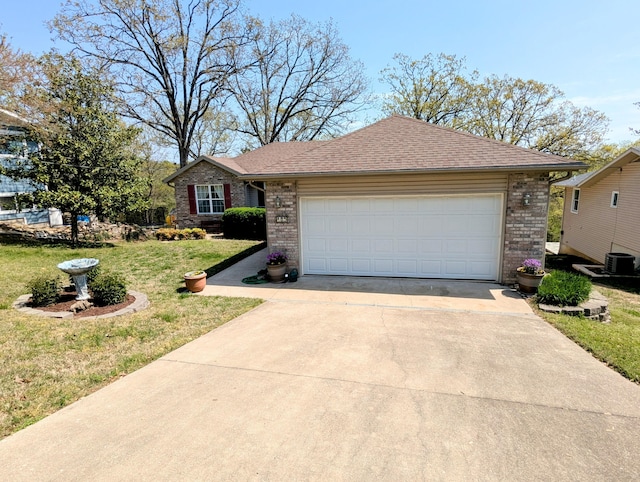 single story home with driveway, central AC unit, brick siding, a front lawn, and an attached garage