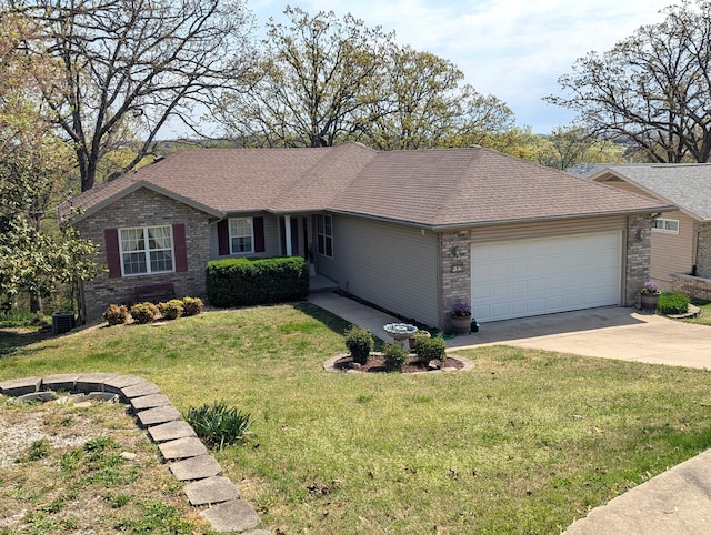 ranch-style home with roof with shingles, a front lawn, brick siding, a garage, and concrete driveway