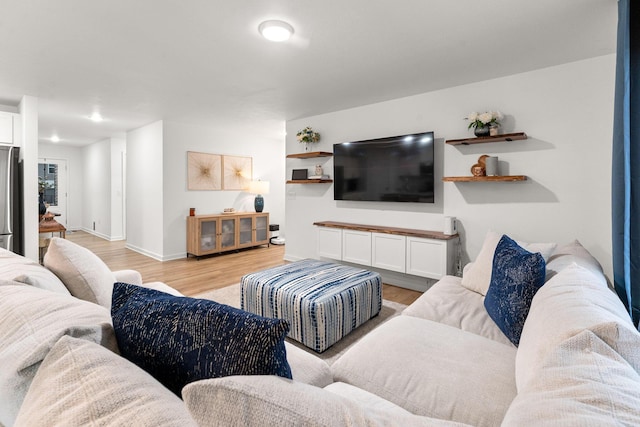 living room featuring baseboards and light wood finished floors