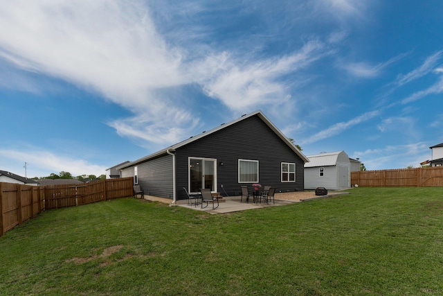 back of property with a yard, a patio, and a fenced backyard