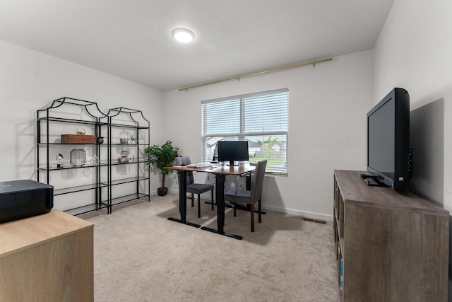 carpeted office featuring baseboards and visible vents