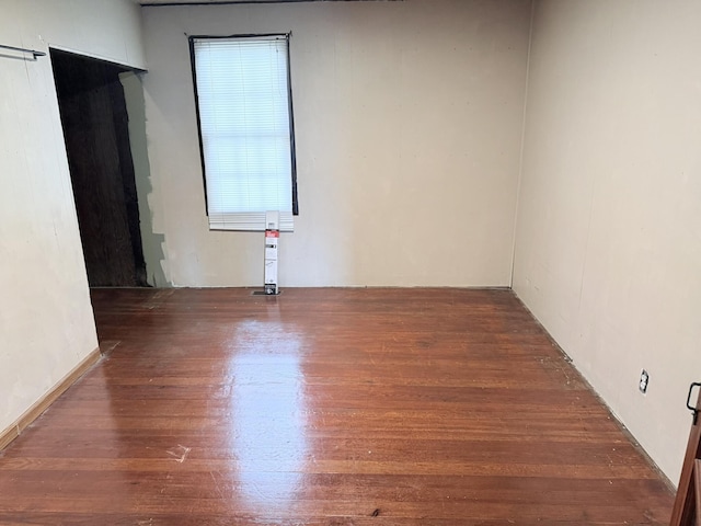 empty room with wood finished floors